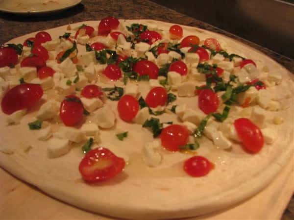cheese pizza topped with tomatoes