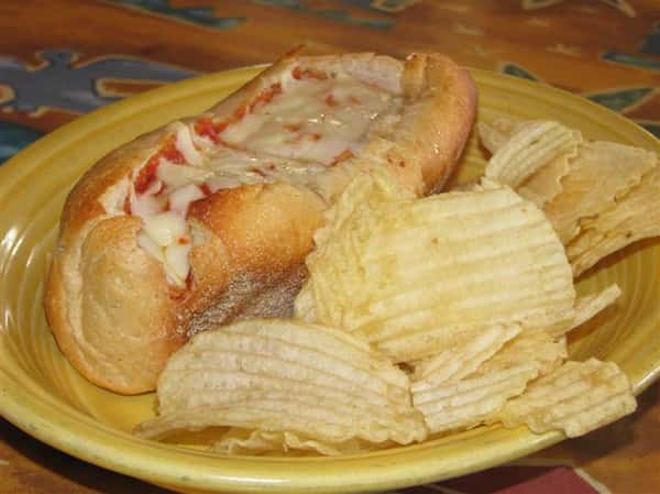 potato chips and a cheese pizza in a bun