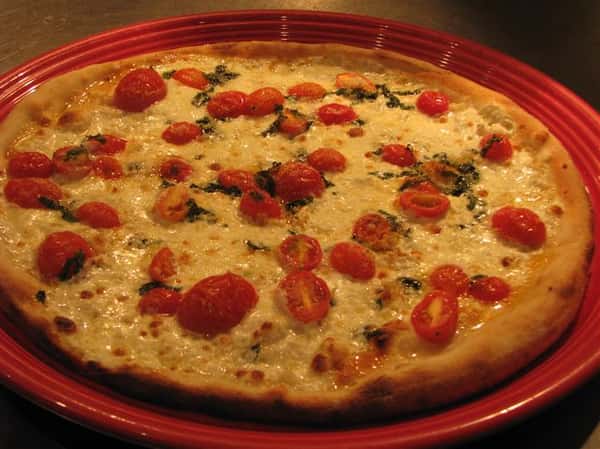 cheese pizza topped with tomatoes