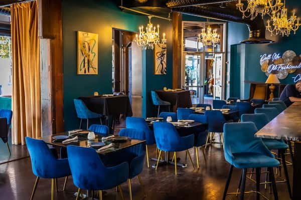 Dining room with blue velvet upholstered chairs