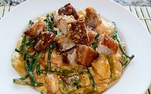 Crispy pork belly served over traditional Filipino mixed vegetables in a rich, savory sauce.