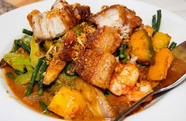 A savory Filipino dish of crispy pork belly (lechon kawali) cooked with mixed vegetables in a rich, flavorful sauce.