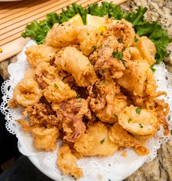 Crispy fried calamari rings lightly battered and served golden brown with fresh garnish.