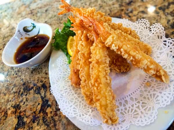 Light and crispy shrimp tempura served with dipping sauce for a delicious crunchy seafood treat.