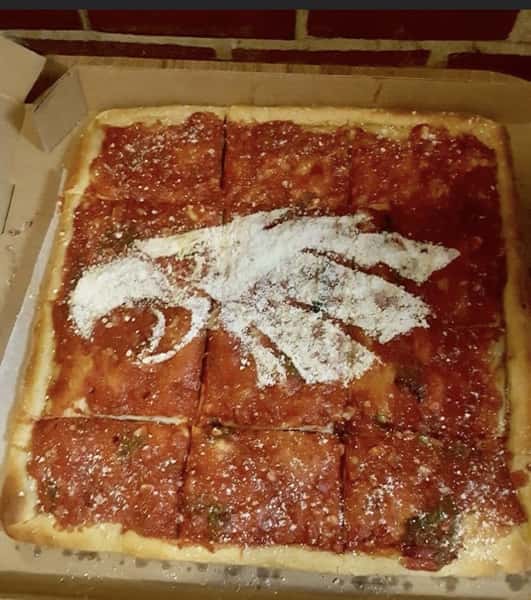 eagles logo topped on sicilian pizza