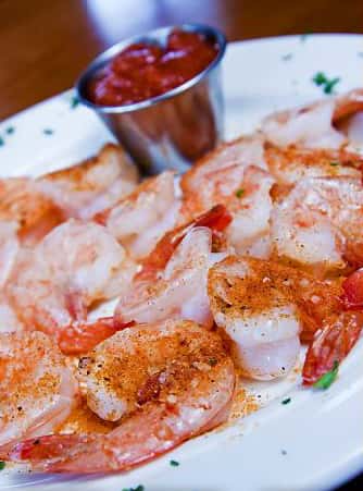 plate of shrimp with cocktail sauce