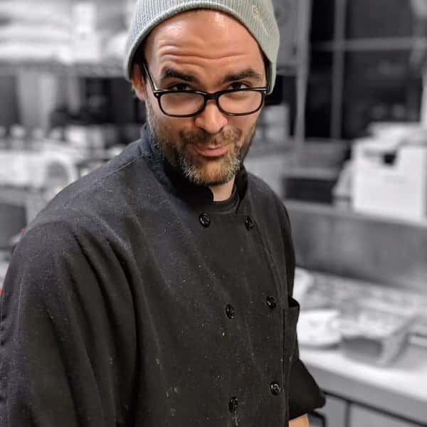 chef posing for a photo inside the kitchen