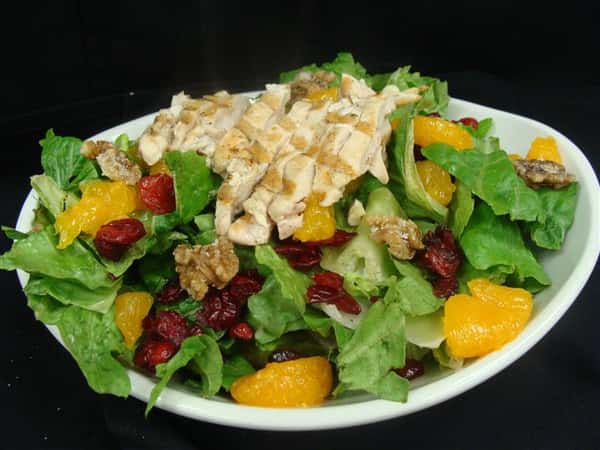 grilled chicken, cranberries and mango on salad