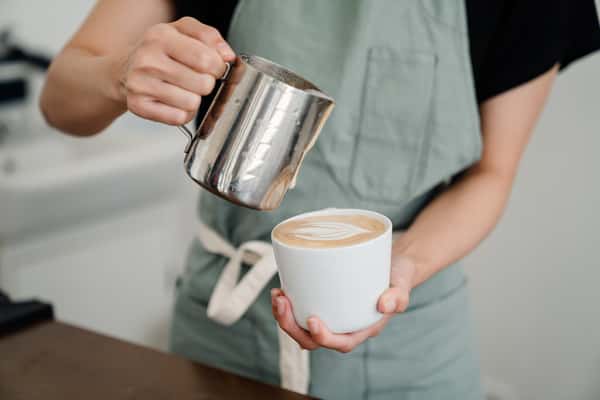 barista pouring coffee