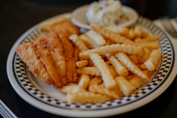 A satisfying plate of crispy fried fish served with golden French fries and creamy coleslaw. This classic comfort meal delivers a delicious balance of crunch and flavor, making it a popular choice for a hearty lunch.