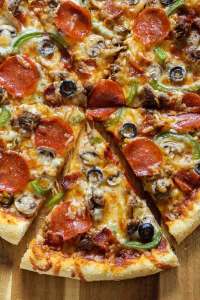 Our homemade recipe of dough tossed topped with our homemade special sauce, covered with a blend of our finest cheese ￼ topped with sausage, mushrooms, pepperoni onions, peppers, and olives