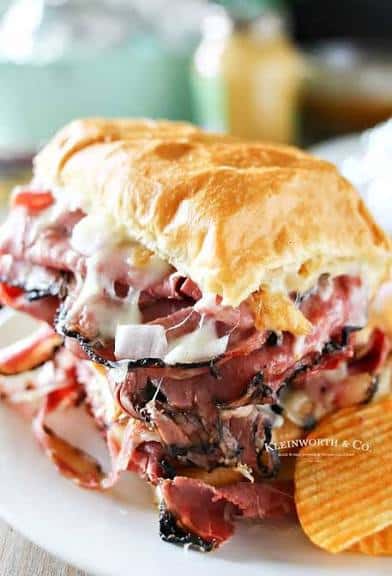 Fence sliced turkey pastrami cooked over the grill melted Swiss cheese, lettuce, and tomato