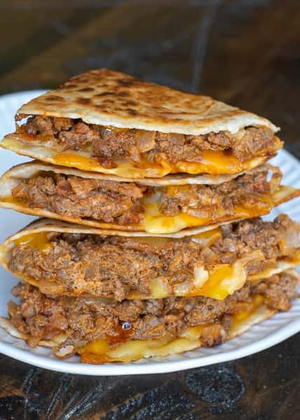 Chopped burger mixed with a blend of cheese stuffed into a tortilla grilled perfect perfection served with sour cream