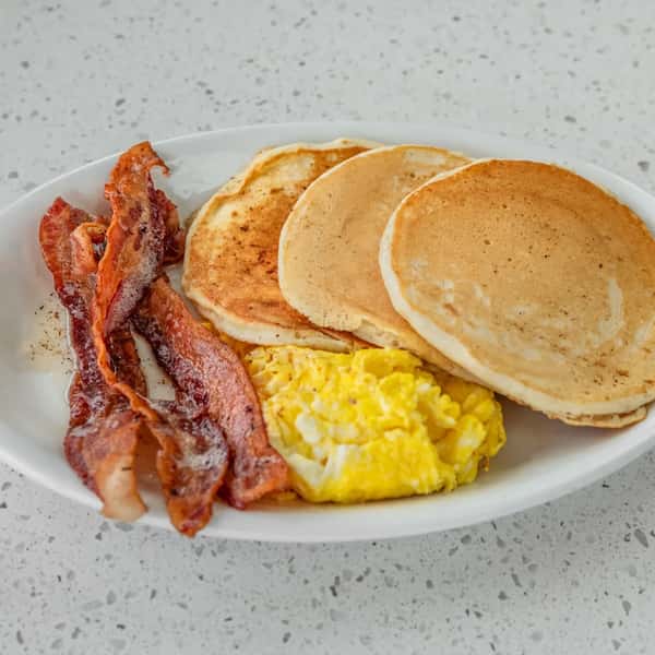 Three pancakes served with eggs and your choice of bacon or sausage