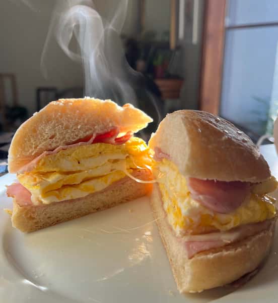 Sliced turkey cooked in the grill served with eggs topped with multi cheese