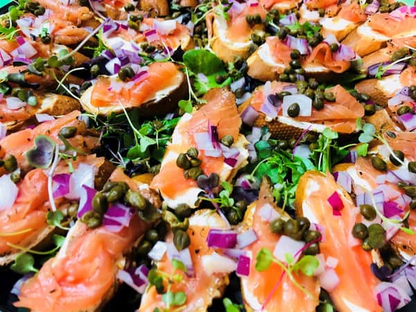 ahi tuna garnished with pine nuts, red onion pieces and herbs