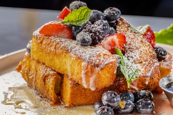 French toast drizzled in Lechera and topped with berries and fresh mint