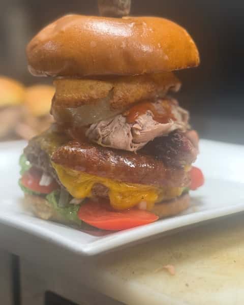 Smokehouse Burger doesn't play nice. Stacked with brisket, pulled pork, sausage, cheddar cheese, cole slaw, and an onion ring, it hits hard and leaves no room for boring. Lettuce, tomato, and onion are available upon request. 🔥🍔

#DoubleSSmokehouse #SmokehouseBurger #BBQBurger #BurgerObsessed