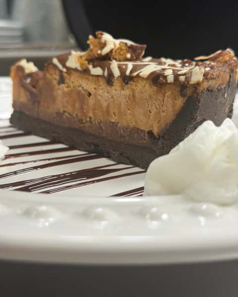Have you tried Peanut Butter High PIe at Double S Smokehouse yet? 🥜 Creamy peanut butter, milk chocolate, a chocolate cookie crust, caramel, and peanut butter cups come together in one seriously rich slice that dessert fans won't forget. 🍫 #DoubleSSmokehouse #PeanutButterHighPIe #DessertCravings