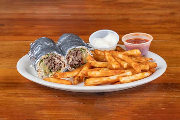 Middle Eastern shawarma wrap served with crispy fries and dipping sauces in Houston.