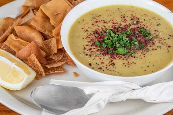 Traditional Middle Eastern lentil soup served with toasted pita and fresh lemon.