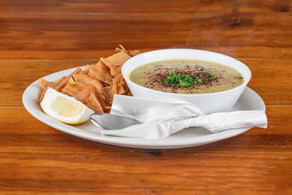 Traditional Middle Eastern lentil soup served with toasted pita and fresh lemon.