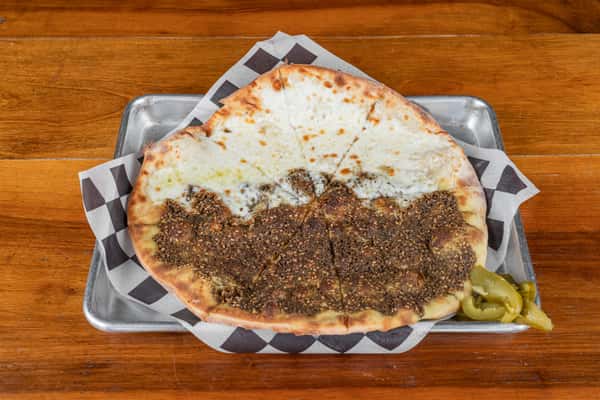 Traditional zaatar manakish flatbread with melted cheese at Nara Cafe in Houston.