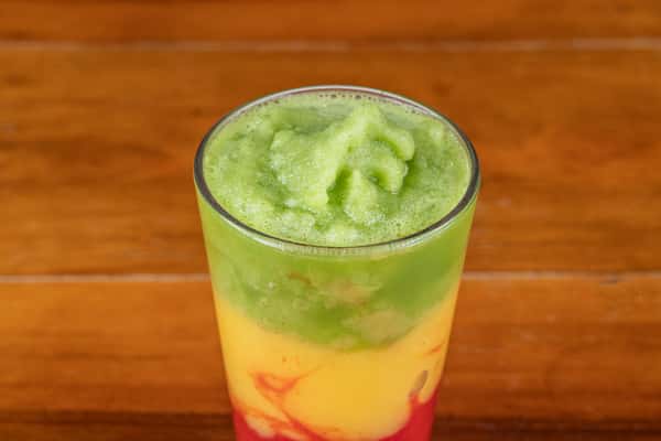 Layered tropical frozen drink in green, yellow, and red served at Nara Cafe Houston.