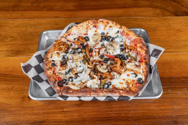 Fresh-baked pizza topped with chicken, vegetables, olives, and melted cheese at Nara Cafe.