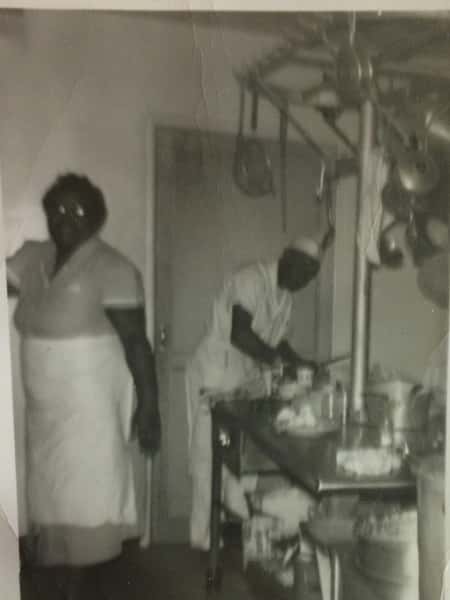 Vintage black and white photo of two cooks in the kitchen