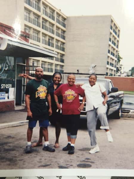 Four people standing in front of The Busy Bee