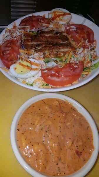 Grilled Chicken Salad with hardboiled egg, tomato, cucumber, Cheddar and mozzarella cheese on top of mixed greens and a side of soup