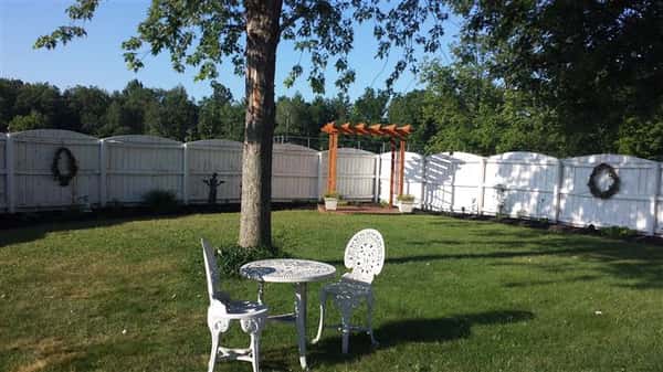 Outdoor shot of Bella Domani garden with a metallic table with two chairs