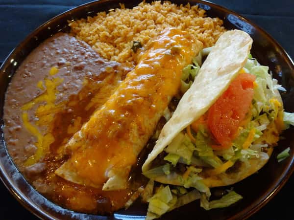 Enchilada covered with cheese. Taco with lettuce and tomato