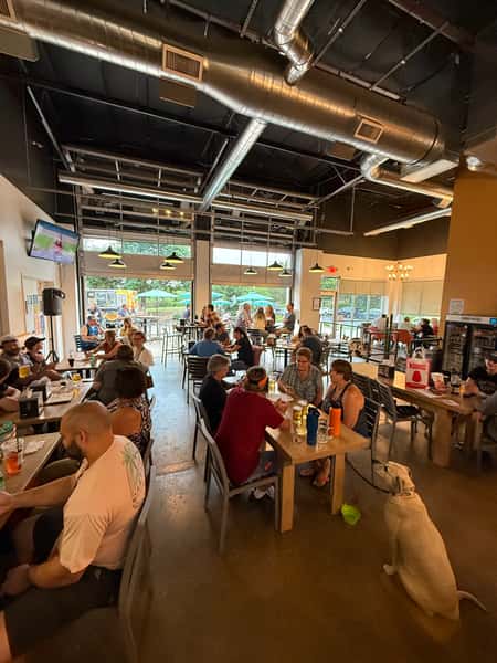 Interior of Old 121 Oak St location with large groups and indoor/outdoor seating