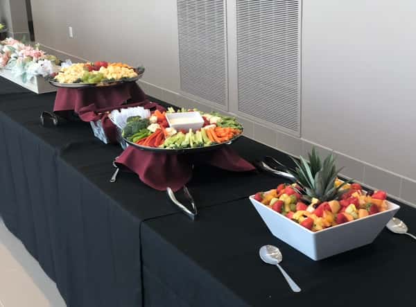 Three different cater options on a table with a black mantle provided by Red's Catering event in Windham, NH