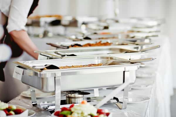 server helping with catered meal