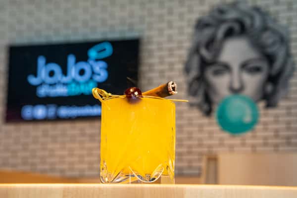 JoJo's Smokin' Hot Blonde cocktail in front of the iconic face of Madonna