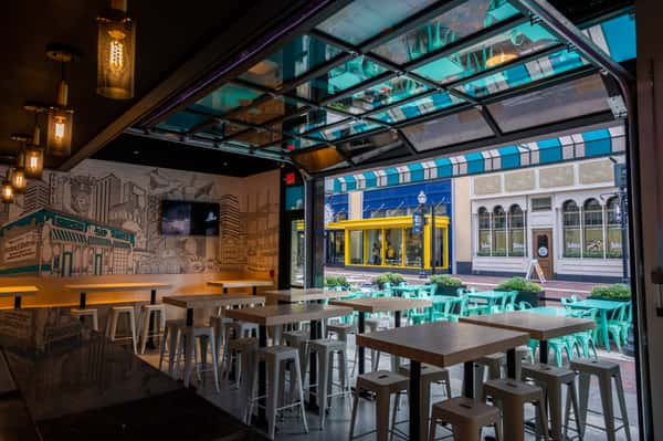 A view of the outdoor patio through the bar and garage door exit