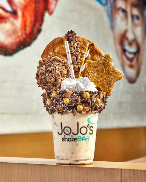 Gold Digger Biggie Shake - Caramel Toffee Shake topped with a toffee donut hole, gold star marshmallow, toffee pretsel, & macadamia nut cookie