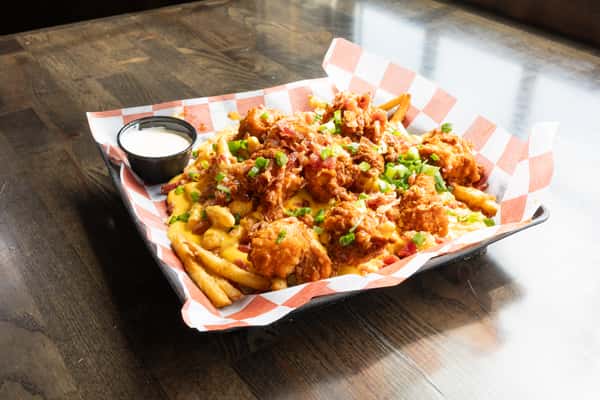loaded chicken fries with melted cheese, bacon, green onions, and ranch dipping sauce