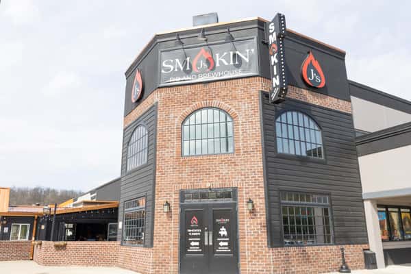 Smokin J's Rib and Brewhouse exterior with brick facade, black accents, and bold restaurant signage