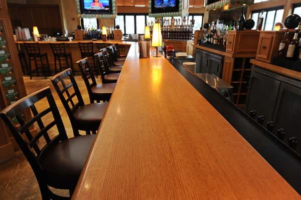 Empty Wood bar with chairs lined up along side