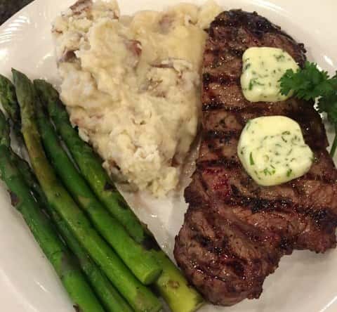 Steal with butter slap on top with side of asparagus and mashed potatoes