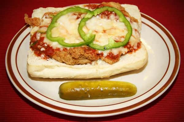 chick parm sandwich with a pickle on the side