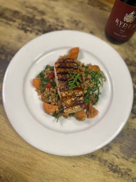 Maple Miso Glazed Salmon served with a warm harvest vegetable farro salad.