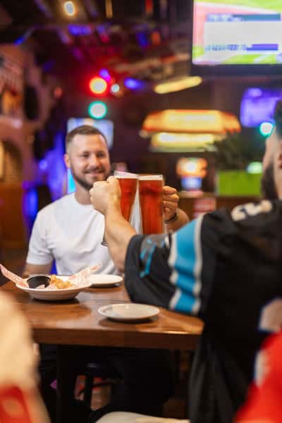Two men cheering beers