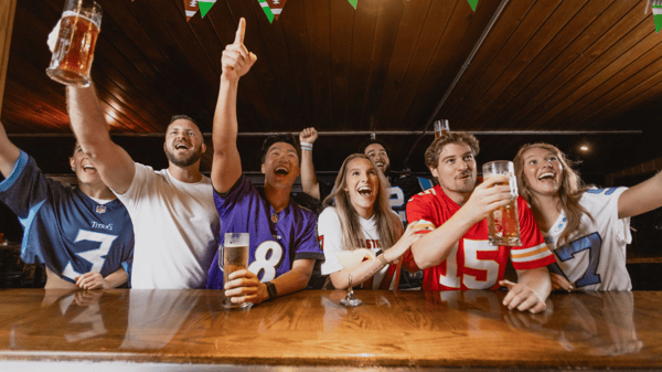 Sports fans cheering for football teams 