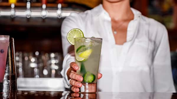 A catering bartender serving a cocktail at Carolina Ale House