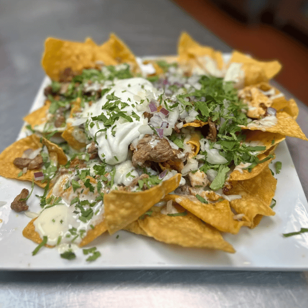 Nachos with saucy toppings
